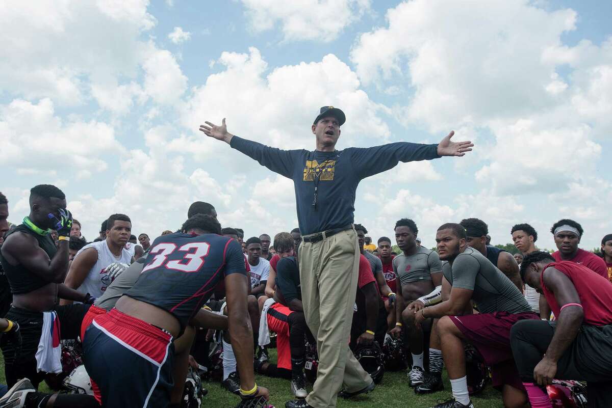 Michigan Head Coach Jim Harbaugh speaks to participants during the Coach Jim Harbaugh's Elite Summer Football Camp, Friday, June 5, 2015, at Prattville High School in Prattville, Ala.