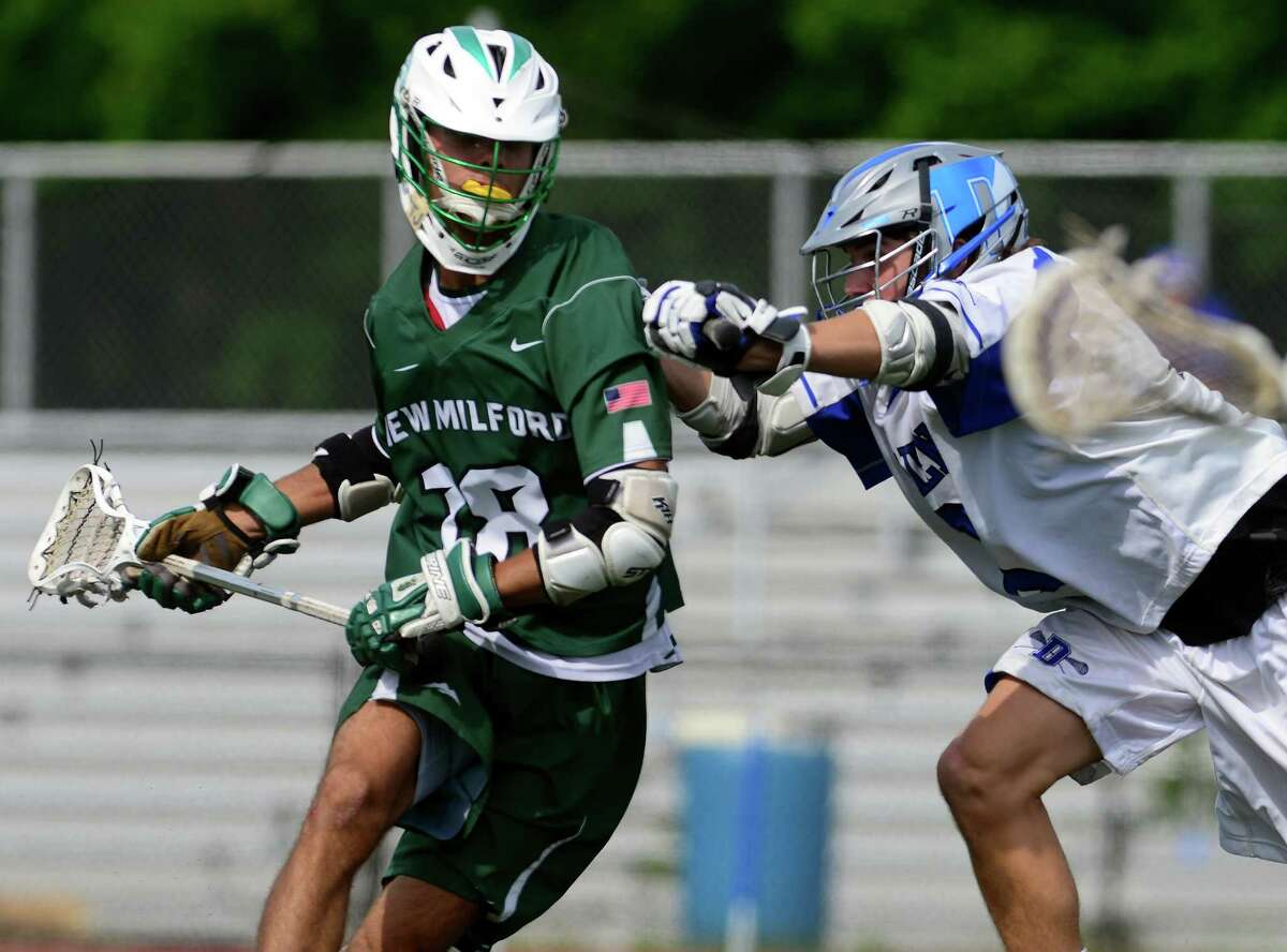 Darien's Joe Hardison, right, tries to fend off New Milford's Jameson Steinhardt as he drives towards the goal, during Class L lacrosse quarterfinals action in Darien, Conn., on Saturday June 6, 2015.