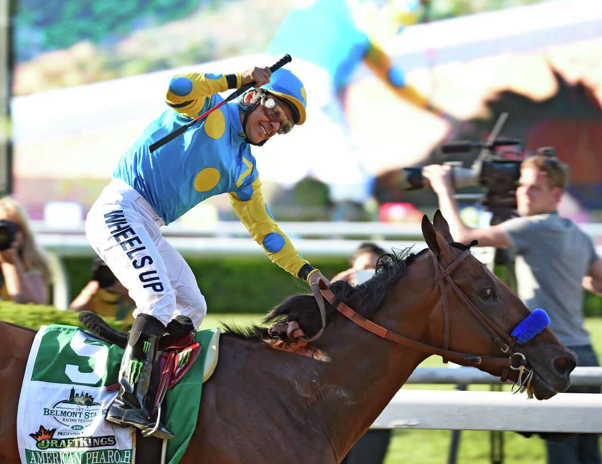 American Pharoah ridden by Victor Espinoza made his way to the record books by winning the 147th running of the Belmont Stakes and thoroughbred racing's Triple Crown June 6, 2015 at Belmont Park in Elmont, N.Y. (Skip Dickstein/Times Union)
