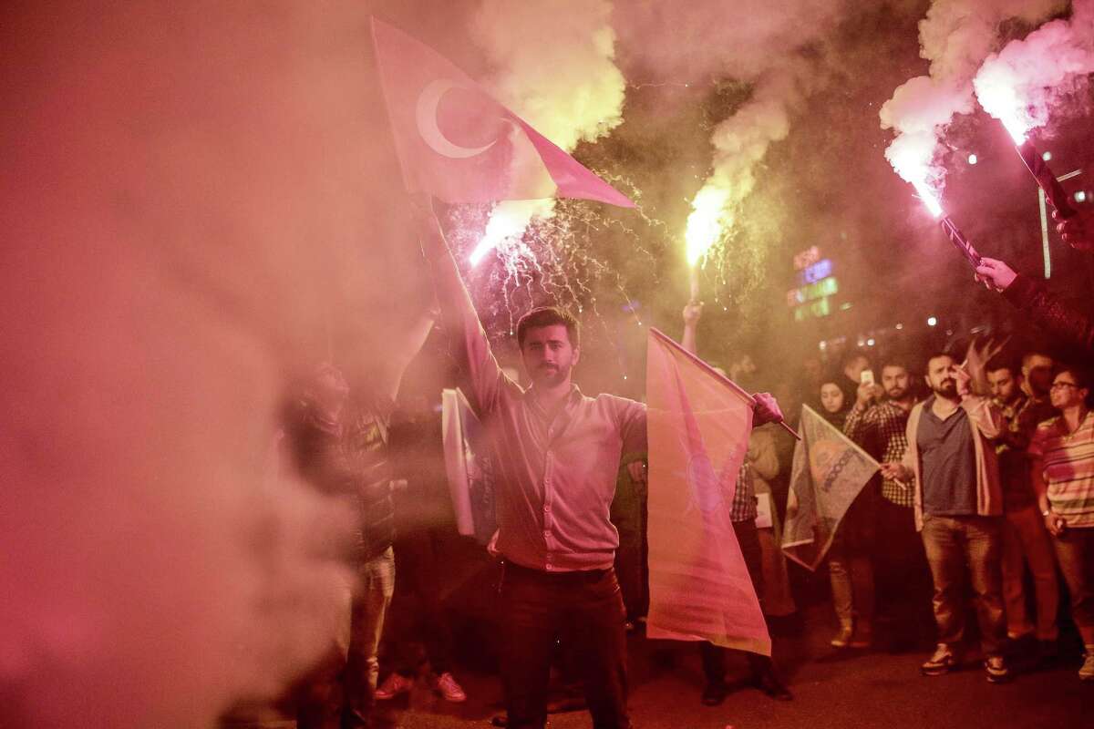 Justice and Development Party (AKP) supporters light flares at Istanbul`s AKP headquarters on June 7, 2015. Turkey's Islamic-rooted ruling party lost its absolute parliamentary majority in legislative elections, dealing a severe blow to strongman President Recep Tayyip Erdogan's ambition to expand his powers. In a sensational result that shakes-up Turkey's political landscape, the pro-Kurdish People's Democratic Party (HDP) easily surpassed the 10 percent barrier needed to send MPs to parliament. AFP PHOTO / YASIN AKGULYASIN AKGUL/AFP/Getty Images