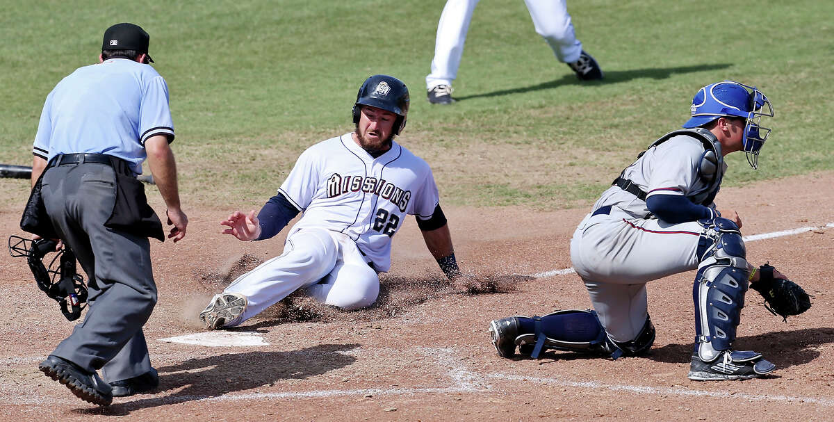 Missions' Jason Hagerty scores the go-ahead run on a two-run single by Missions' Rey Bruguera (not pictured) as Northwest Arkansas Naturals' Parker Morin waits for the throw during the eight inning Sunday June 7, 2015 at Nelson W. Wolff Municipal Stadium. The Missions won 10-5.