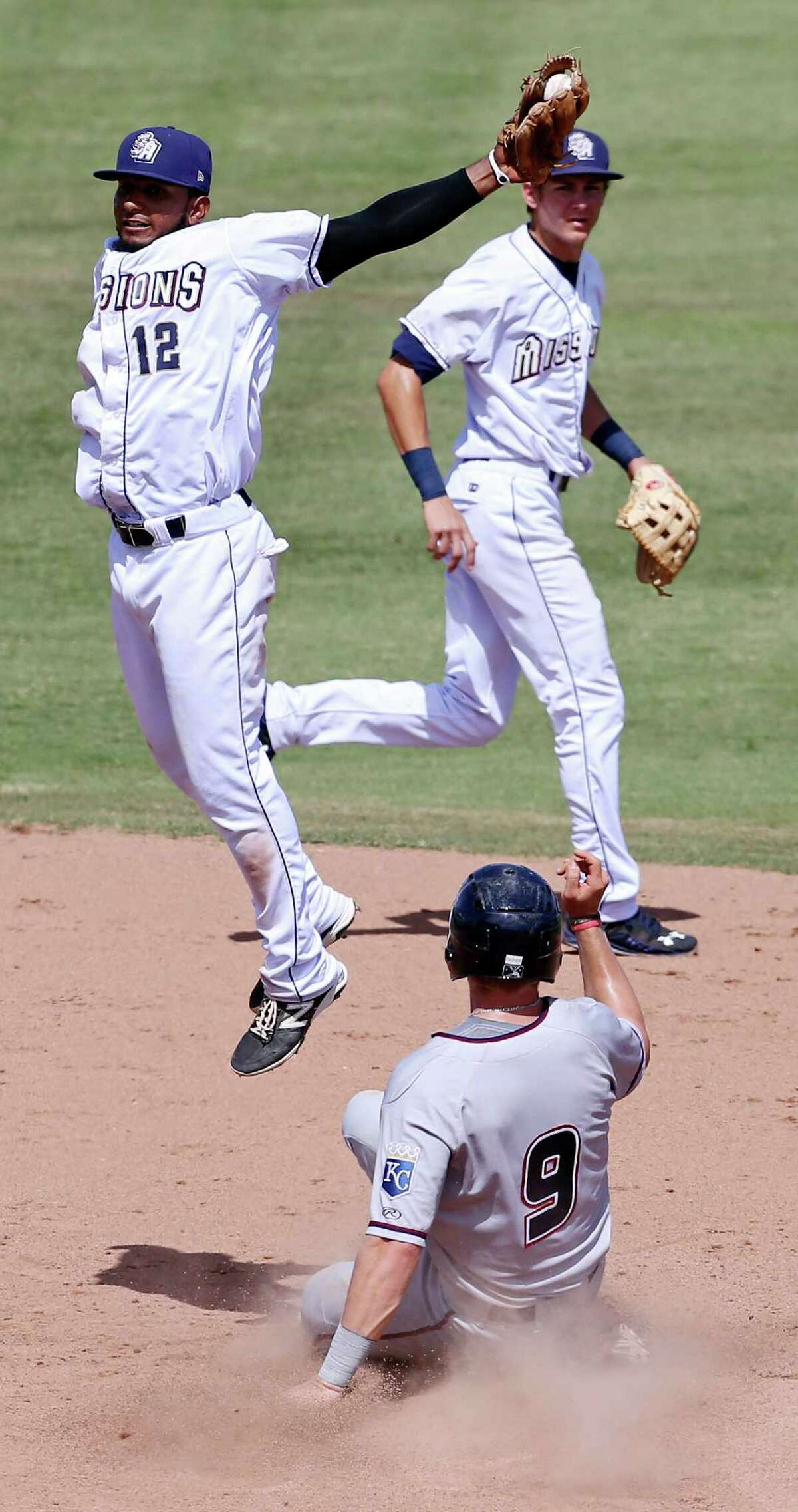 Northwest Arkansas Naturals' Hunter Dozier steals second under Missions' Rey Bruguera as Missions' Trea Turner (rear) looks on during the eight inning Sunday June 7, 2015 at Nelson W. Wolff Municipal Stadium. The Missions won 10-5.