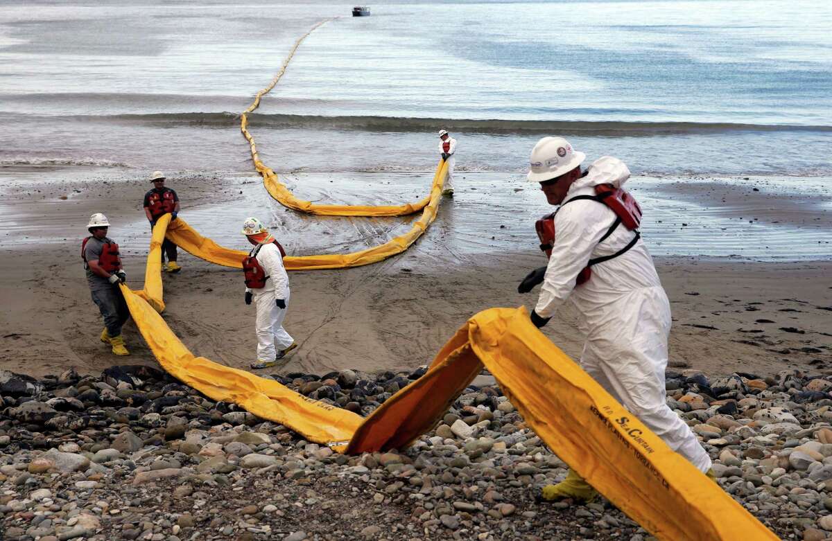 Workers prepare oil containment boom at Refugio State Beach, north of Goleta, Calif., after a pipeline ruptured in May. Houston-based Plains All American Pipeline owns the pipeline. ﻿
