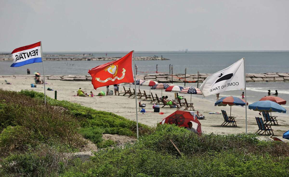 A view of the Marine flag and "Come and Get It" flag are seen between 59th St. and 61st. St. on Wednesday, June 3, 2015 in Galveston, TX. Maceo is claim that he owns that stretch of beach, although the Galveston Park Board says otherwise. Maceo has intimidated the guy who has a contract with the Park Board to rent beach chairs there. The Park Board is ready to take Maceo to court because his insistence that he owns the beach could endanger plans to put new sand in front of the seawall as well as other Park Board projects for improving the beach for visitors.