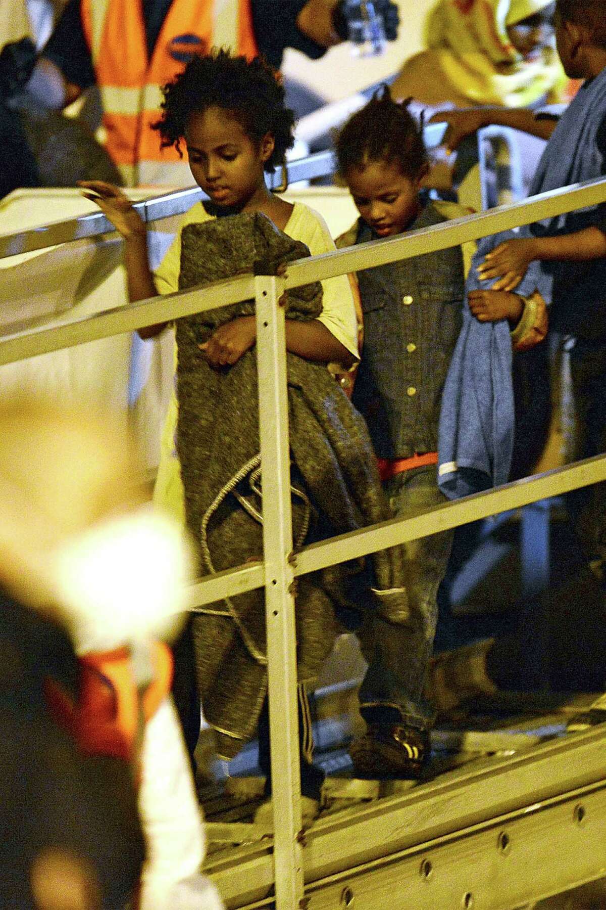 Young migrants disembark from the "Phoenix" ship upon their arrival in the port of Augusta on the eastern coast of Sicily on June 7, 2015. Italy's wealthy North vowed that it would refuse to accommodate any more migrants as thousands more were rescued in the Mediterranean by a multinational flotilla of ships. As another frantic weekend of rescues unfolded, nearly 6,000 people were plucked to safety from packed fishing boats and rubber dinghies off Libya. AFP PHOTO / GIOVANNI ISOLINOGIOVANNI ISOLINO/AFP/Getty Images