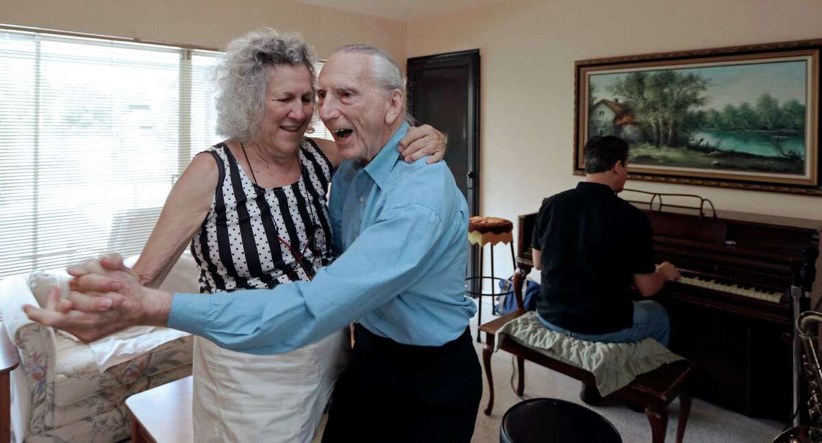 Al Karp and his wife, Saundra, dance to the music their son Larry plays on the piano at their home in North Miami Beach, Fla.