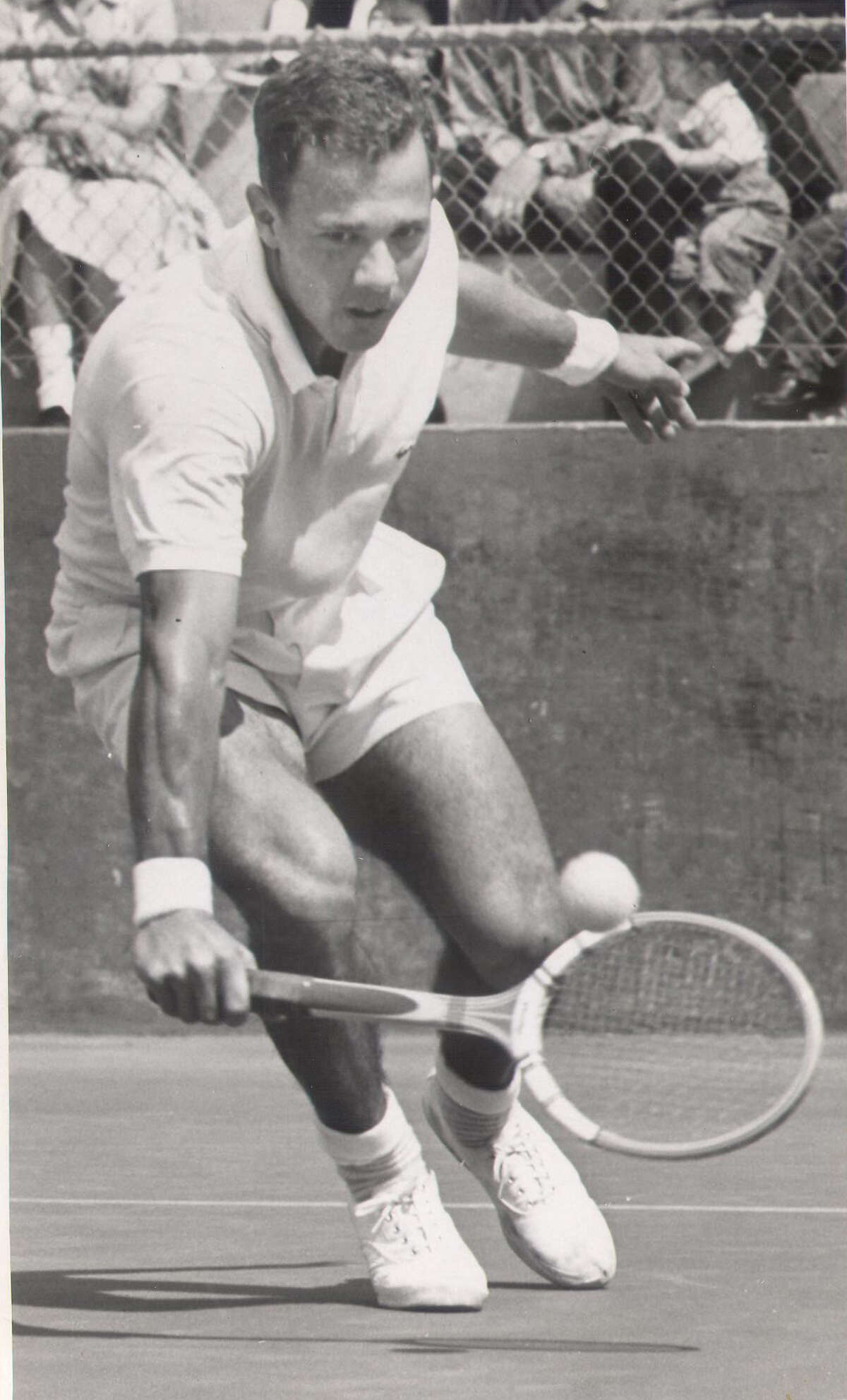 Chuck McKinley returns a shot in a 1962 match vs. Neal Marcus from Rice University.
