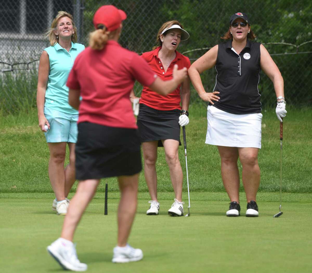 Greenwich women, from left, Patty Waurishuk, Renee Murphy, Maureen Sheehan and Laurie Meek react to a missed putt during the Greenwich High School football annual fundraiser golf tournament at E. Gaynor Brennan Golf Course in Stamford, Conn. Monday, June 8, 2015. Thirty foursomes, a total of 120 people, participated in this year's best-ball tournament to raise money for the Greenwich High School football program.
