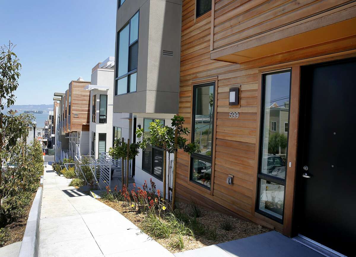 A view looking east on Donahue Street of some finished units Monday June 8, 2015. 88 new housing units are being built and some have moved in to the former Hunters Point Naval Shipyard in San Francisco, Calif. This cleaned up Superfund site is now welcoming the new homeowners.