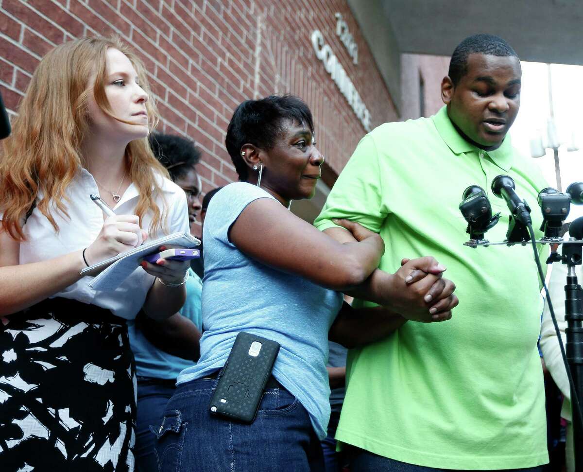 Houston Chronicle columnist, Lisa Falkenberg gets into position as Alfred Brown spoke to the media, with his sister Connie Brown, at his side after his release from the Harris County jail on Monday, June 8, 2015, in Houston.