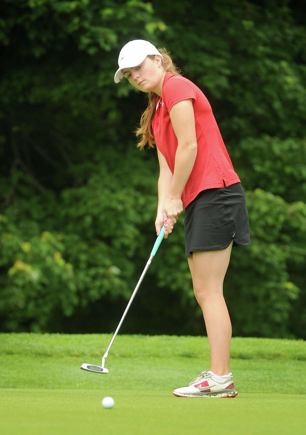 Greenwich's Catherine McEvoy knocks in a birdie putt on the 7th hole of the Girls Golf State Championship at Orange Hills Country Club in Orange, CT on Tuesday, June 9, 2015.