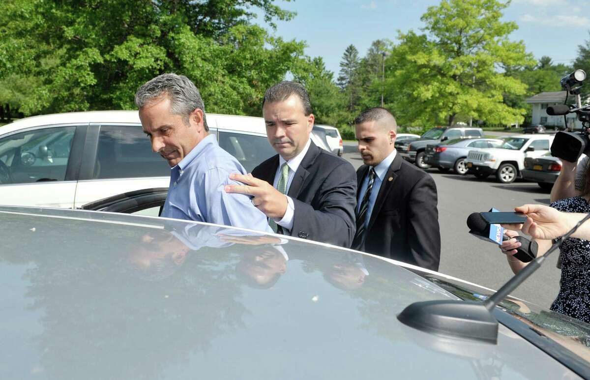 Fred Monroe of Capital Financial Planning is taken away following his appearance in Guilderland Town Court on Wednesday, June 10, 2015, in Guilderland, N.Y. (Paul Buckowski / Times Union)
