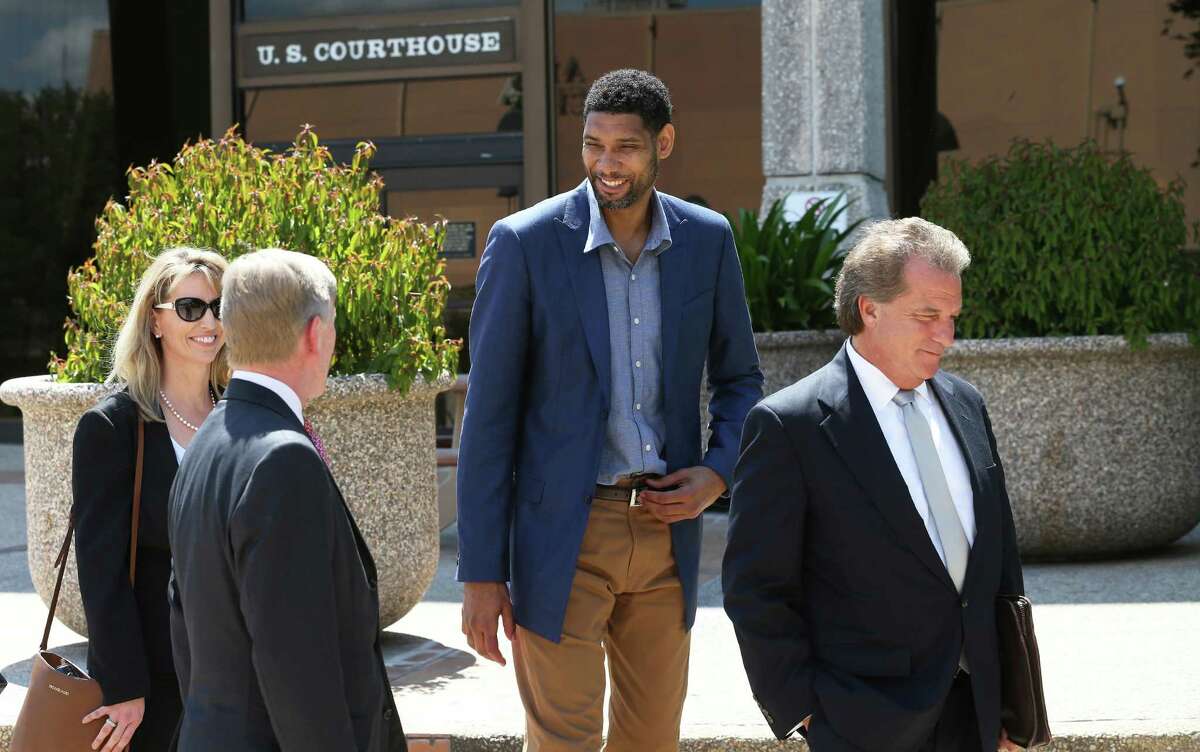 Tim Duncan enjoys a lighter moment with his legal team after he makes an appearance in federal court before U.S. District Judge Xavier Rodriguez regarding his lawsuit against Charles Banks on June 10, 2015. From left are financial consultant Wendy Kowalik, attorney J. Tullos Wells, Duncan and attorney Michael D. Bernard.