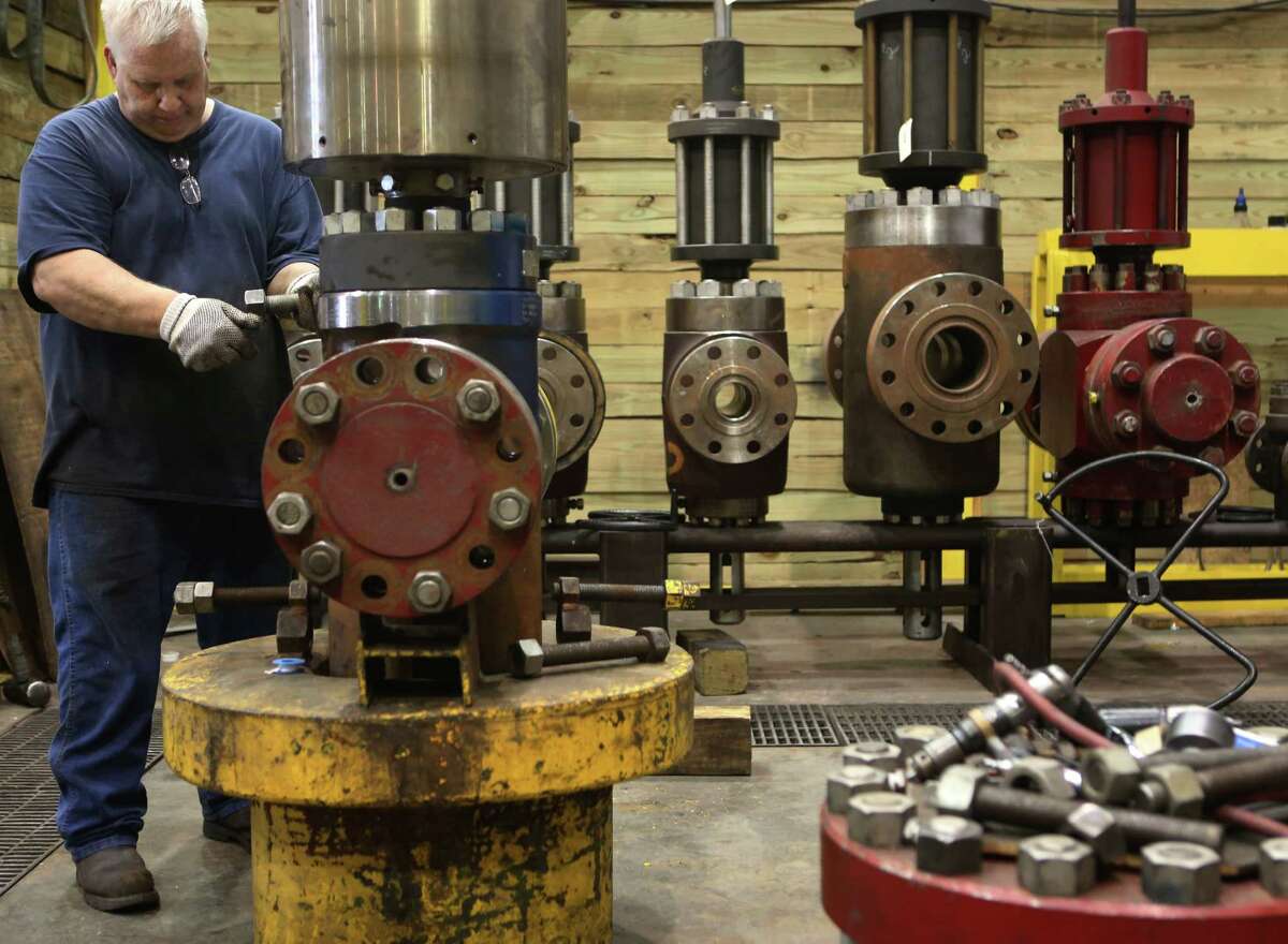Chuck Martin tests a valve at Control Flow, which will be hurt if the Export-Import Bank is shut down.