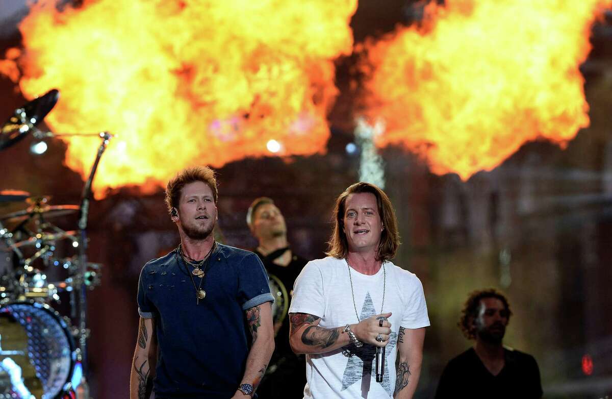 Brian Kelley, left, and Tyler Hubbard of Florida Georgia Line perform on an outdoor stage during the CMT Music Awards on Wednesday, June 10, 2015, in Nashville, Tenn. (Photo by Mark Zaleski/Invision/AP) ORG XMIT: TNMZ118