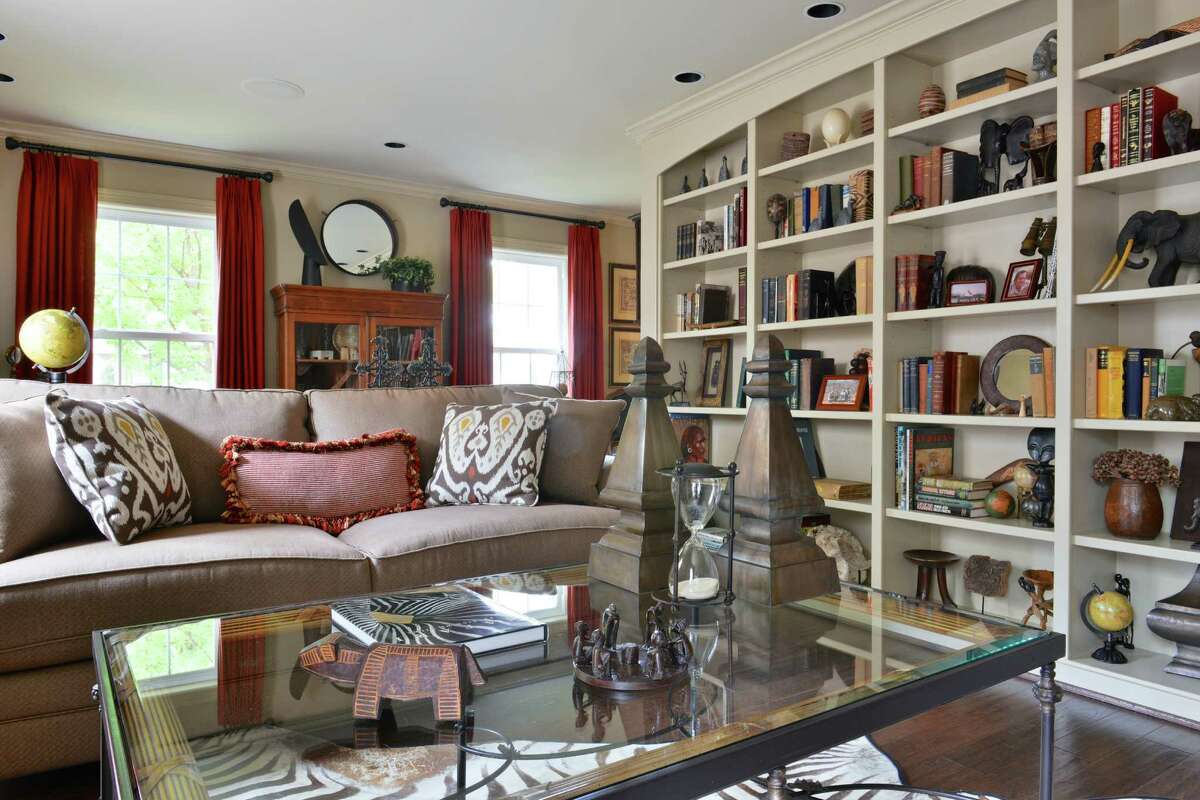 Antique African books line the built-in bookshelves in the living room.
