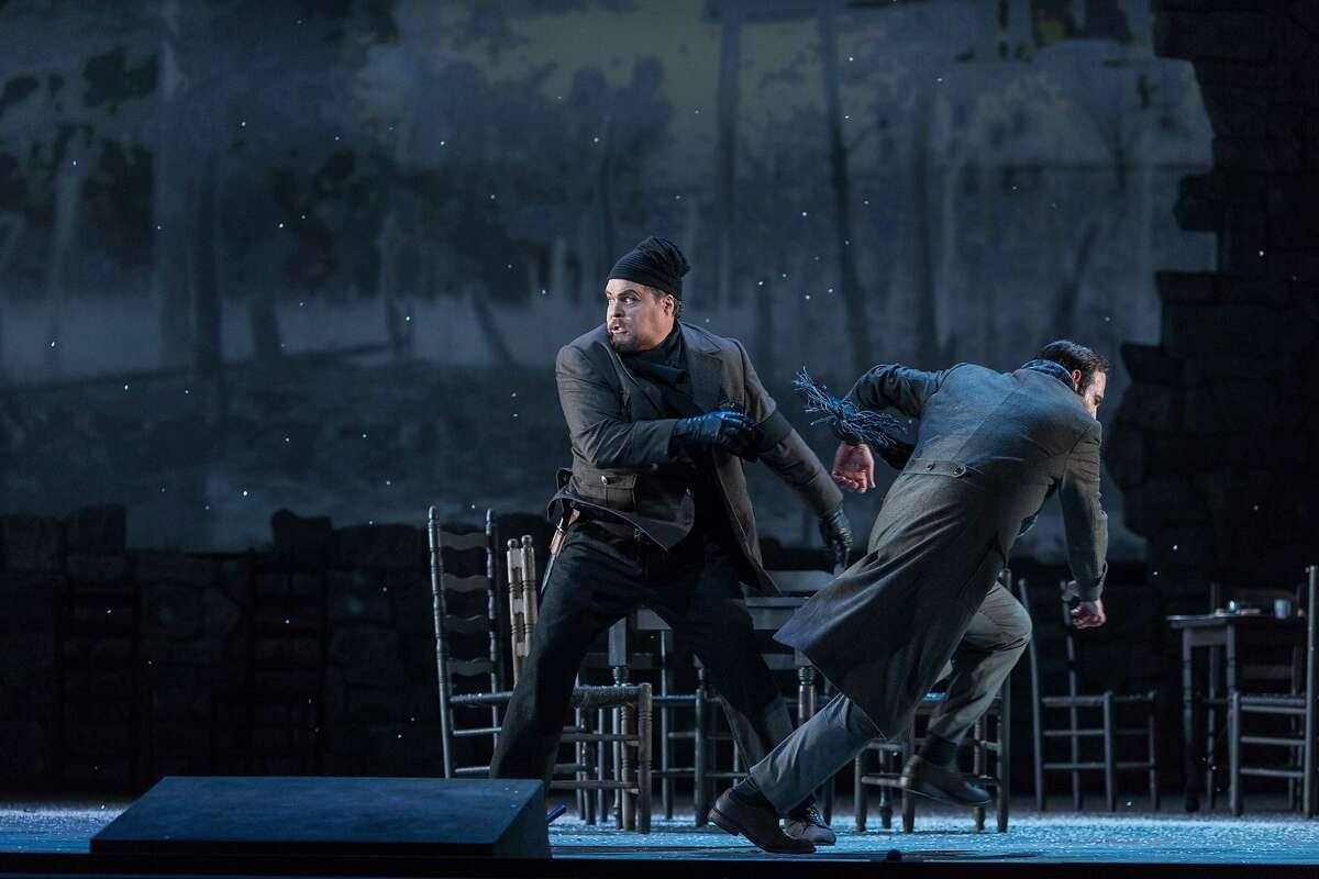 "Giovanni" played by Mark Delavan, center, throws "Michele" played by Dimitri Pittas, in act 1 scene 3 after Michele and Cesira share a kiss while Giovanni, now a fascist, watches and then pulls a gun on them during a performance of "Two Women" at the War Memorial Opera House in San Francisco, Calif., Tuesday, June 9, 2015.