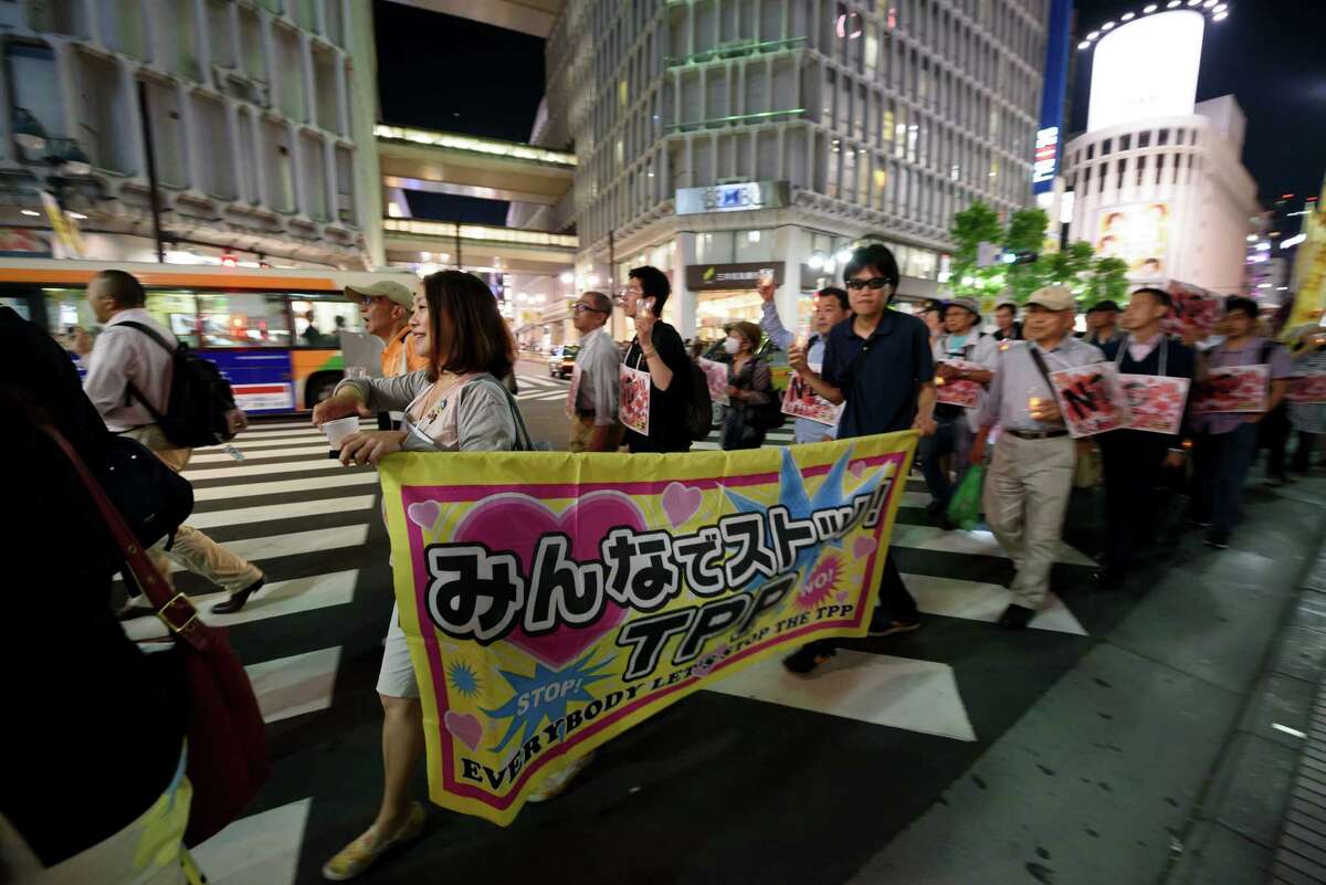 Free trade agreements are eagerly sought by countries around the globe but the feeling isn’t universal. People carry a banner during a protest against the Trans-Pacific Partnership (TPP) trade agreement at the Shibuya district in Tokyo, Japan, on May 26.