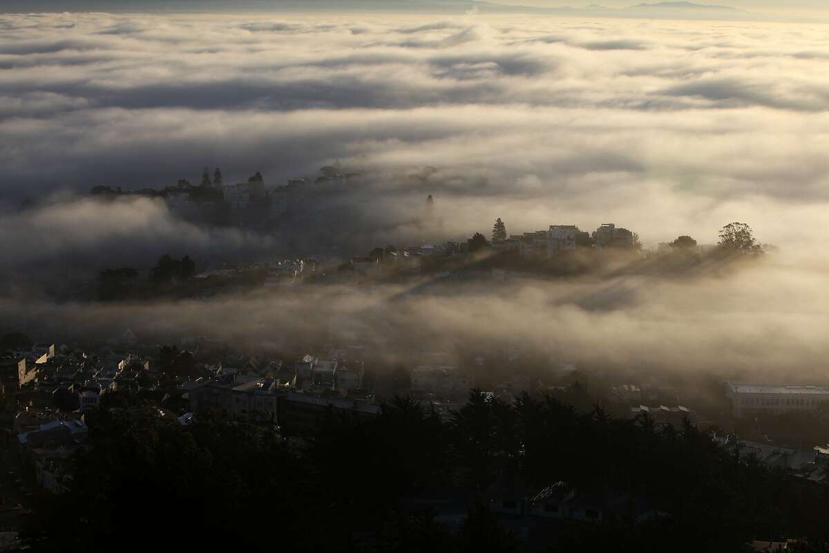 Fog is seen at sunrise looking east from Twin Peaks on November 8, 2013 in San Francisco, Calif.
