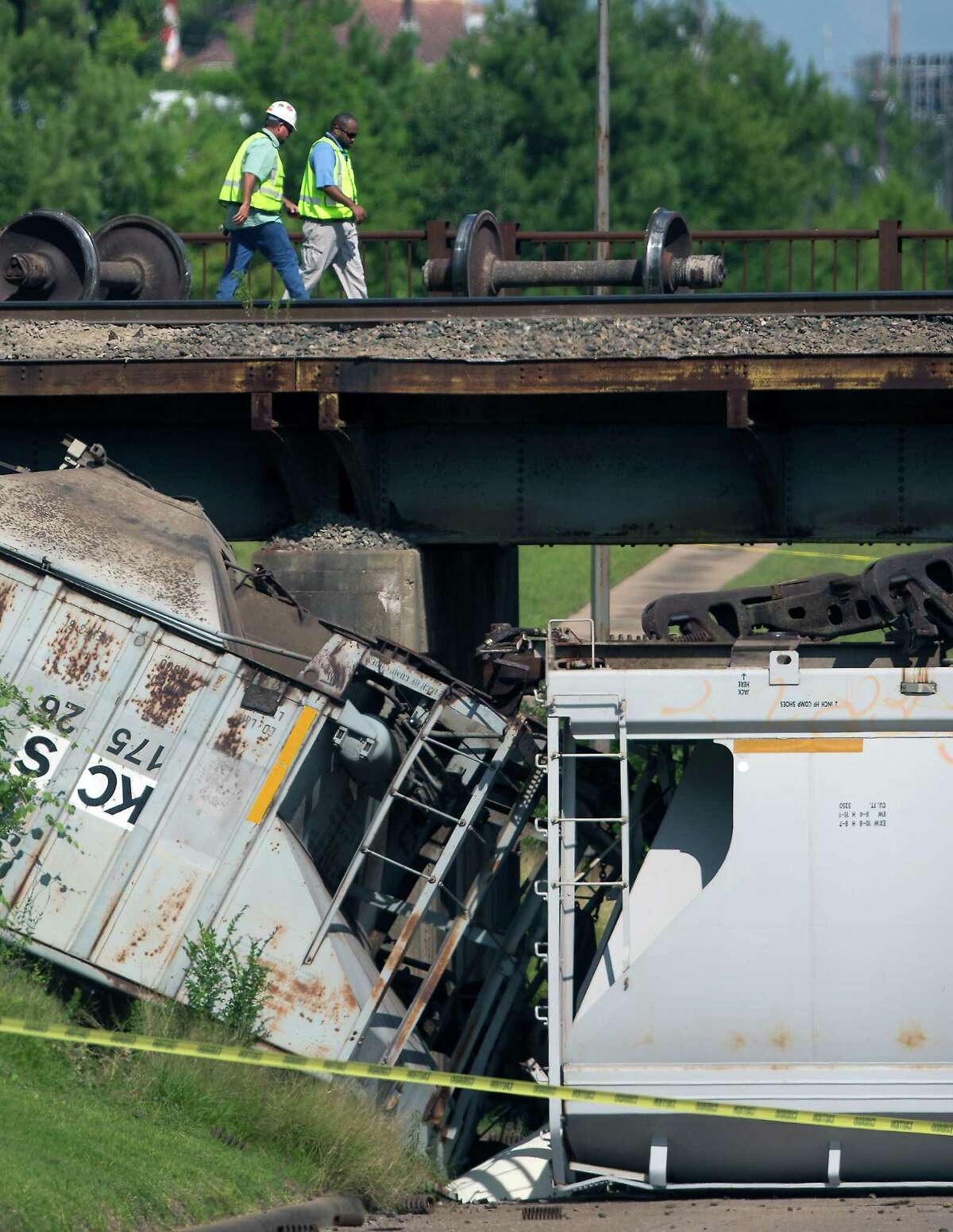 Railcar plunges from overpass to street below