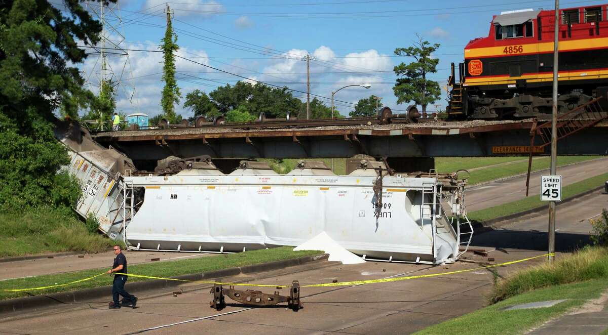 Thursday's derailment of two train cars along Old Katy Road forced traffic to be detoured while authorities investigated and brought in crews to lift the cars back onto the tracks.