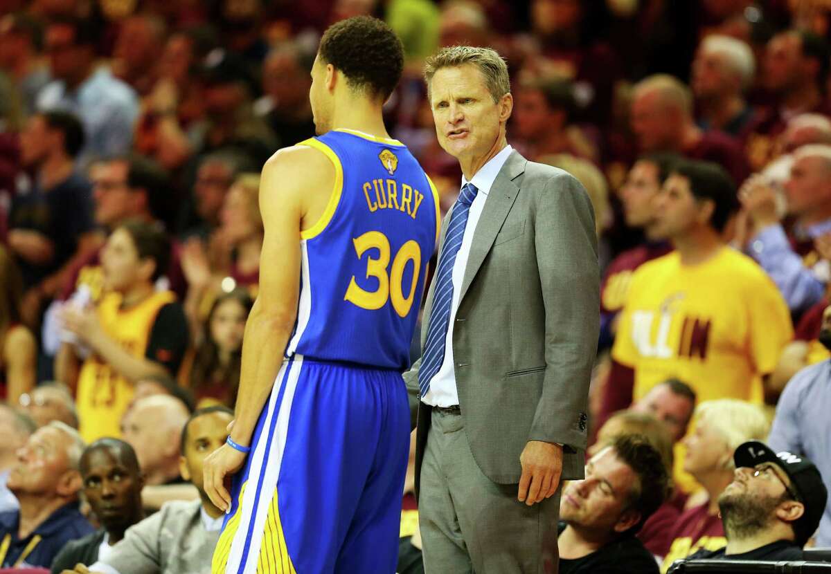 Head coach Steve Kerr of the Golden State Warriors talks to Stephen Curry #30 in the first half against the Cleveland Cavaliers during Game Four of the 2015 NBA Finals at Quicken Loans Arena on June 11, 2015 in Cleveland, Ohio. NOTE TO USER: User expressly acknowledges and agrees that, by downloading and or using this photograph, user is consenting to the terms and conditions of Getty Images License Agreement. (Photo by Ronald Martinez/Getty Images)