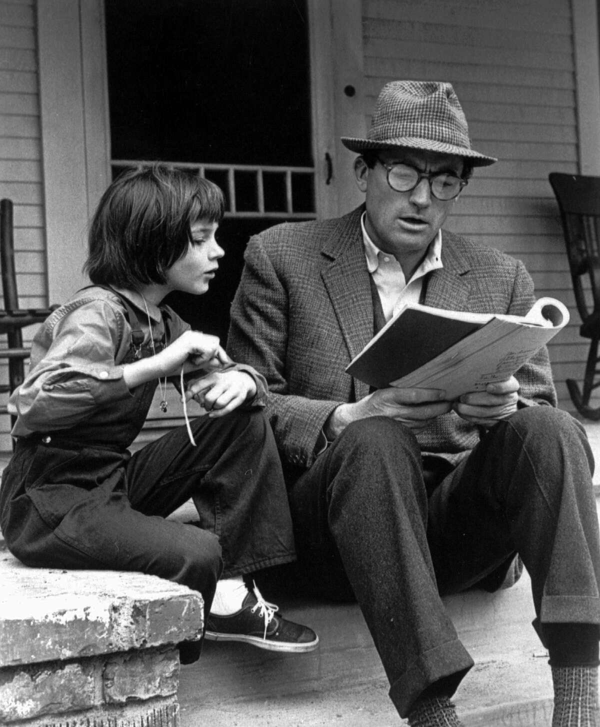 Gregory Peck and 9-year-old Mary Badham study their lines on the set of the film "To Kill a Mockingbird" in 1962.