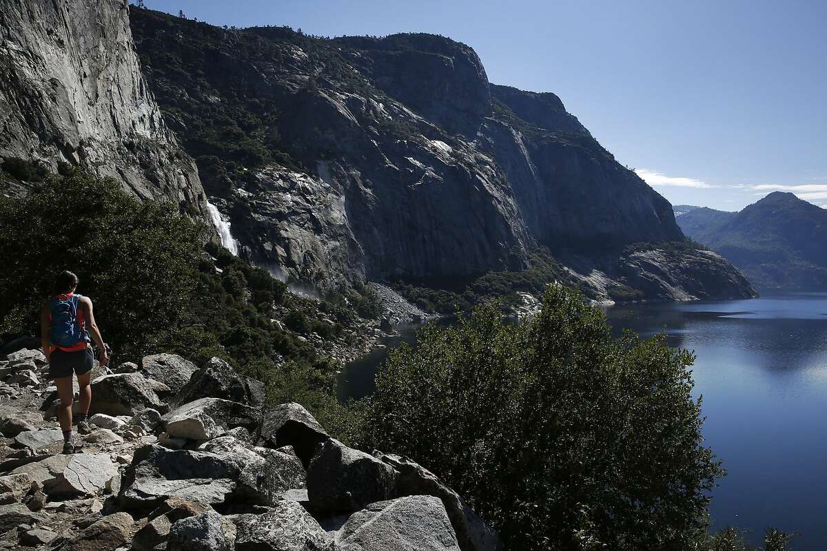 Melissa Callaghan, left, hikes toward Wapama Falls at Hetch Hetchy Reservoir June 12, 2015 in Yosemite National Park, Calif. The 117-billion-gallon reservoir supplies water to millions of Bay Area residents.