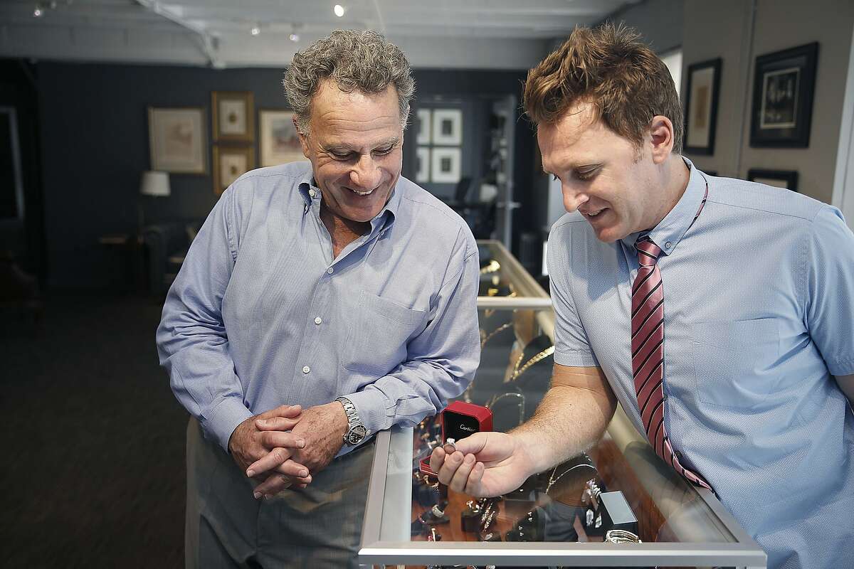 Father-son Joseph Chait (father,left) and Marcus Chait (son, right), look at a Cartier diamond ring just sold this morning at 66Mint in San Francisco, California, on Thursday, June 11, 2015. During the 1950's the asset based lender has evolved into being recognized as one of the premier estate jewelry dealers in the country and has opened a sell center in Silicon Valley this month.