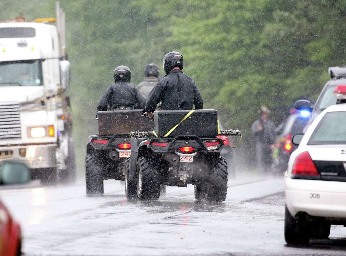 Law enforcement officers use off road vehicles in search of two escapees from Clinton Correctional Facility on Friday, June 12, 2015, near Dannemora, N.Y. Squads of law enforcement officers are searching for David Sweat and Richard Matt, two murderers who escaped from the maximum-security prison in northern New York. (AP Photo/Mike Groll)