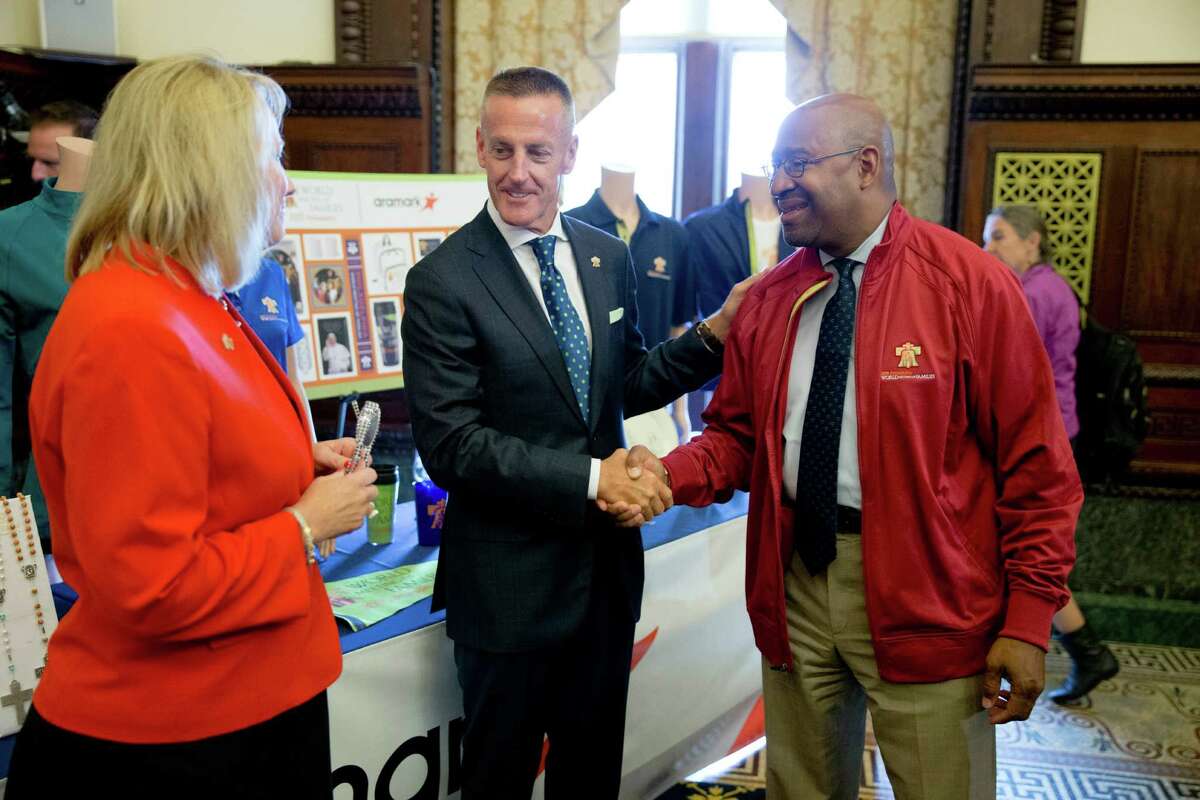 Donna Crilley Farrell of the World Meeting of Families and Aramark CEO Eric Foss (center) and Philadelphia Mayor Michael Nutter talk about the pope’s visit.