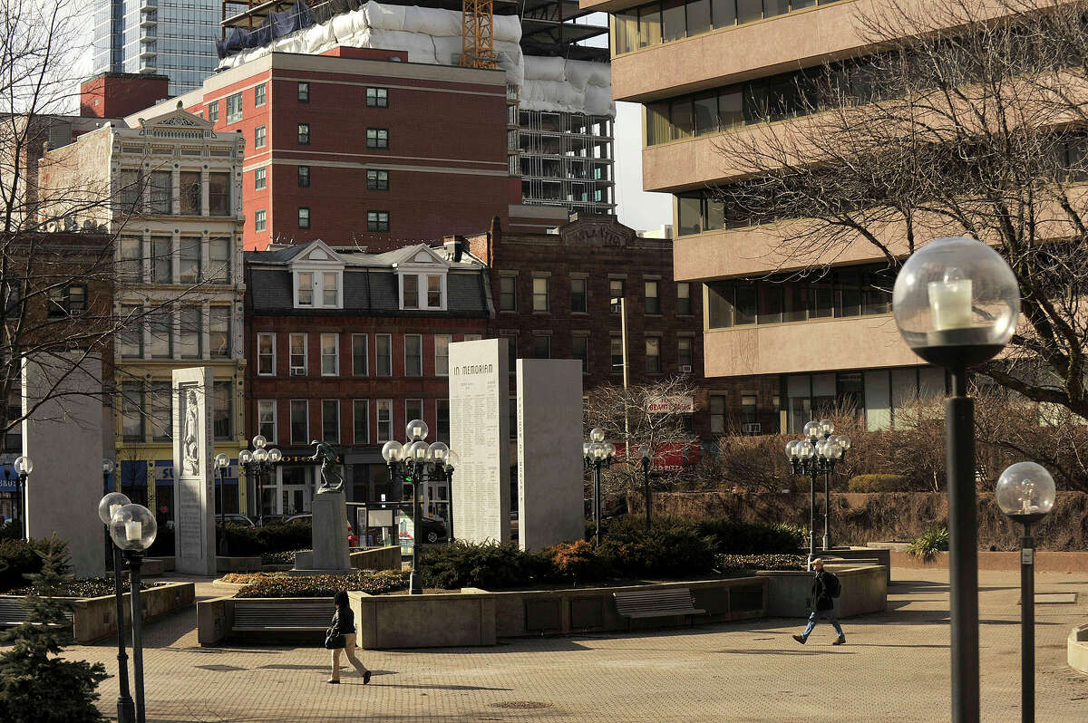 People walk through Veterans Park in downtown Stamford in early spring.