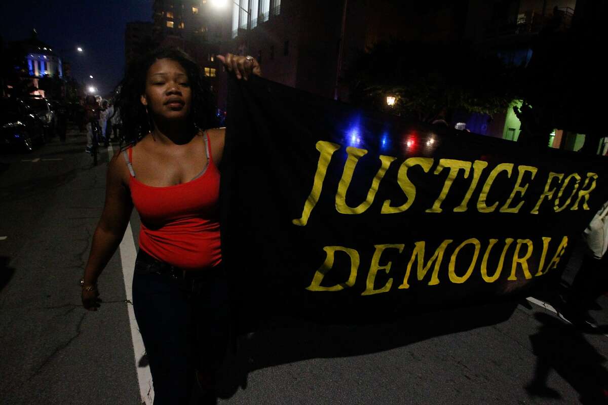 A protester marches with other to protest the shooting of Demouria Hogg by Oakland Police on Saturday, in Oakland, Calif., on Friday, June 12, 2015.