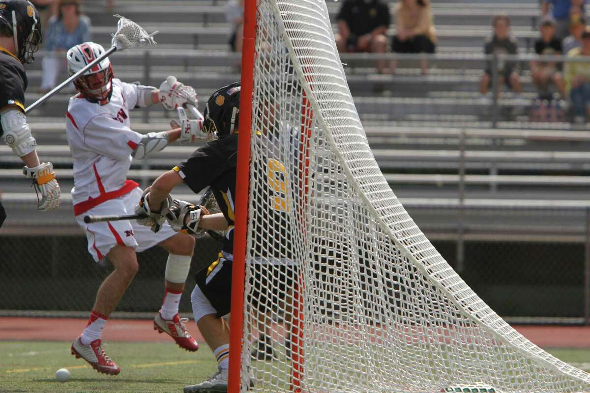 New Canaan's Justin Meichner scores under pressure in the first half against Daniel Hand during the CIAC Class M Boys Lacrosse Championship in Norwalk, Conn. on Saturday, June 13, 2015.