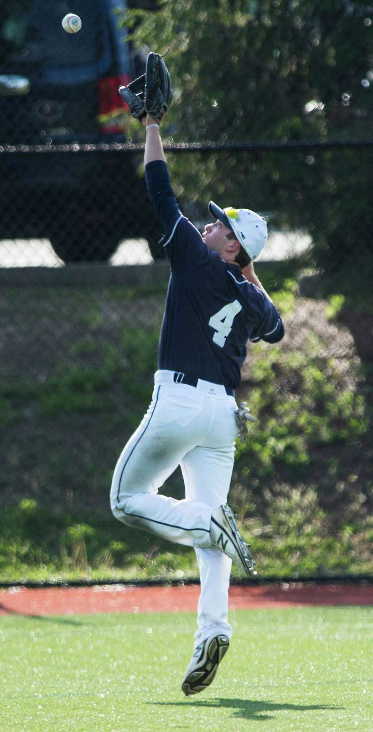 Staples high school outfielder Nathan Panzer catches a flyball during a baseball game against Darien high school played at Darien high school, Darien, CT on Friday, May, 15th, 2015.