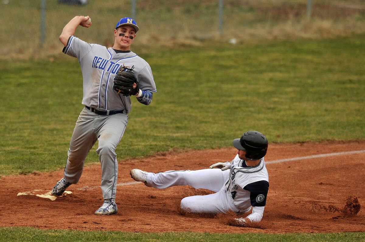 Newtown third baseman Julian Dunn forces out Staples' Nathan Panzer before attempting to finish a double play during the Nighthawks' baseball game against Staples at Staples High School in Westport, Conn., on Wednesday, April 8, 2015. Staples won, 5-4.