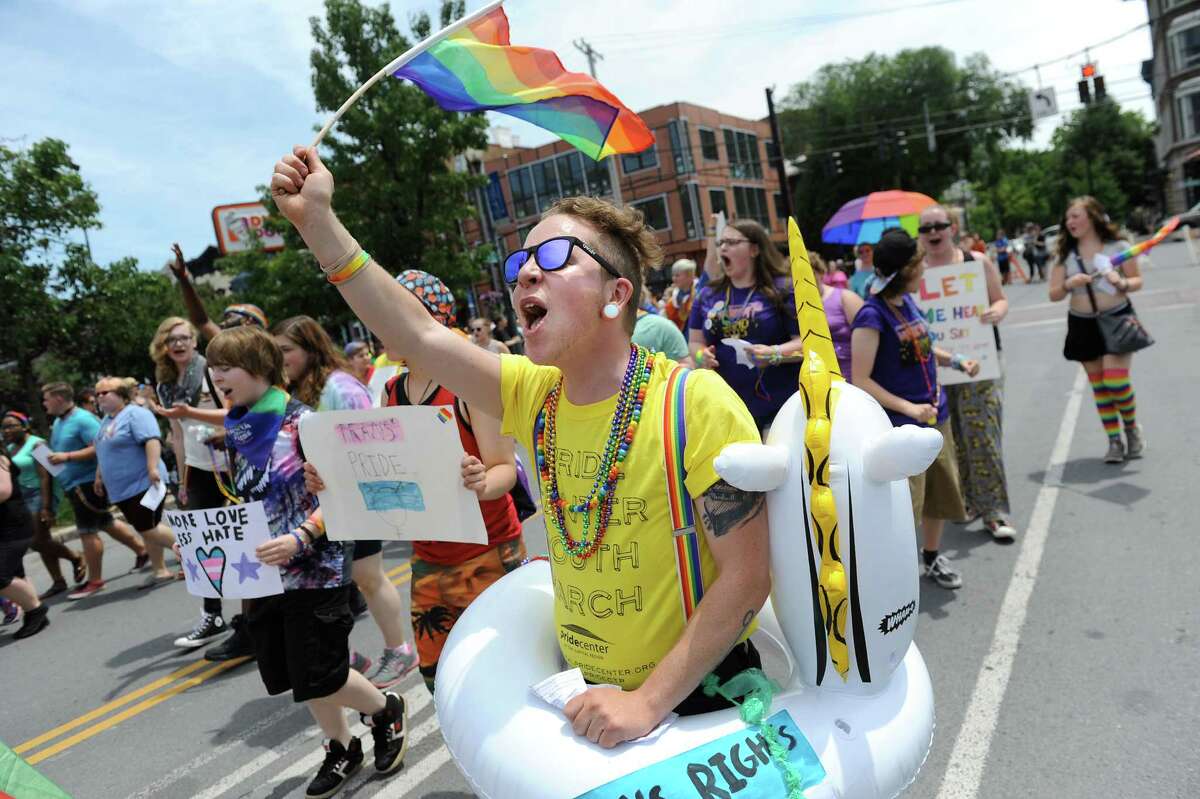 James Shultis, youth program manager of the Pride Center, center, leads his group during the Capital PRIDE Parade on Saturday, June 13, 2015, in Albany, N.Y. (Cindy Schultz / Times Union)