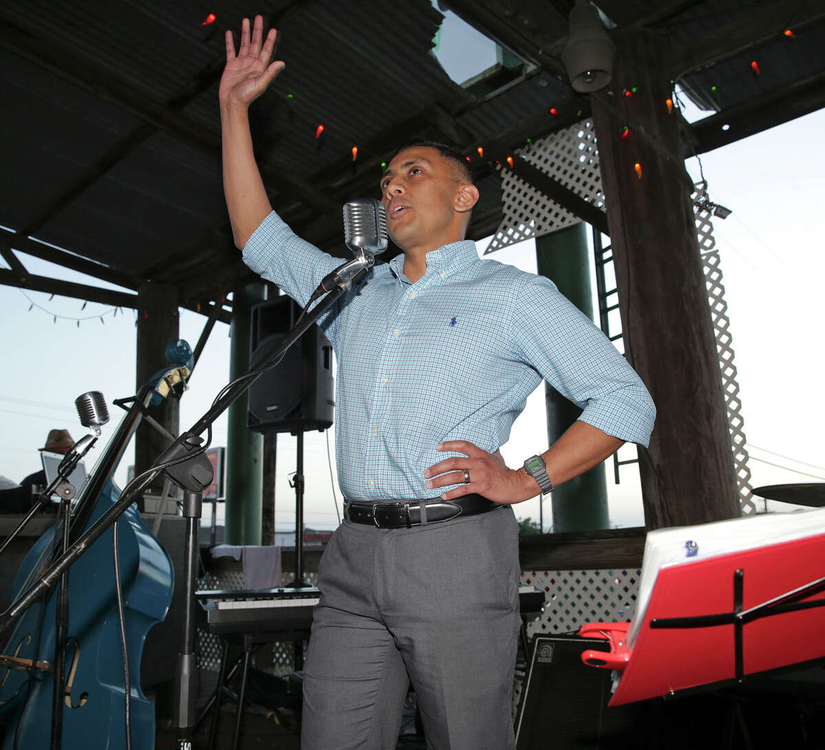 District 7 runoff candidate Cris Medina waves to supporters and makes his victory claim after he arrives to greet supporters at Fatso's Sports Garden to begin an election night party on June 13, 2015.