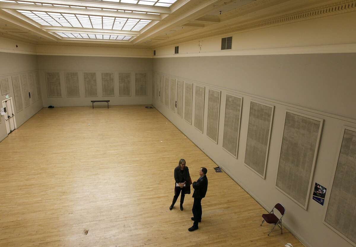 Kelley Kahn and Jens Hillmer tour the Gold Ballroom at the Henry J. Kaiser Convention Center in Oakland, Calif. on Friday, Nov. 21, 2014. Oakland city officials are looking at bids from developers for the historic arena and theater site across from Lake Merritt which has been shuttered since 2005.