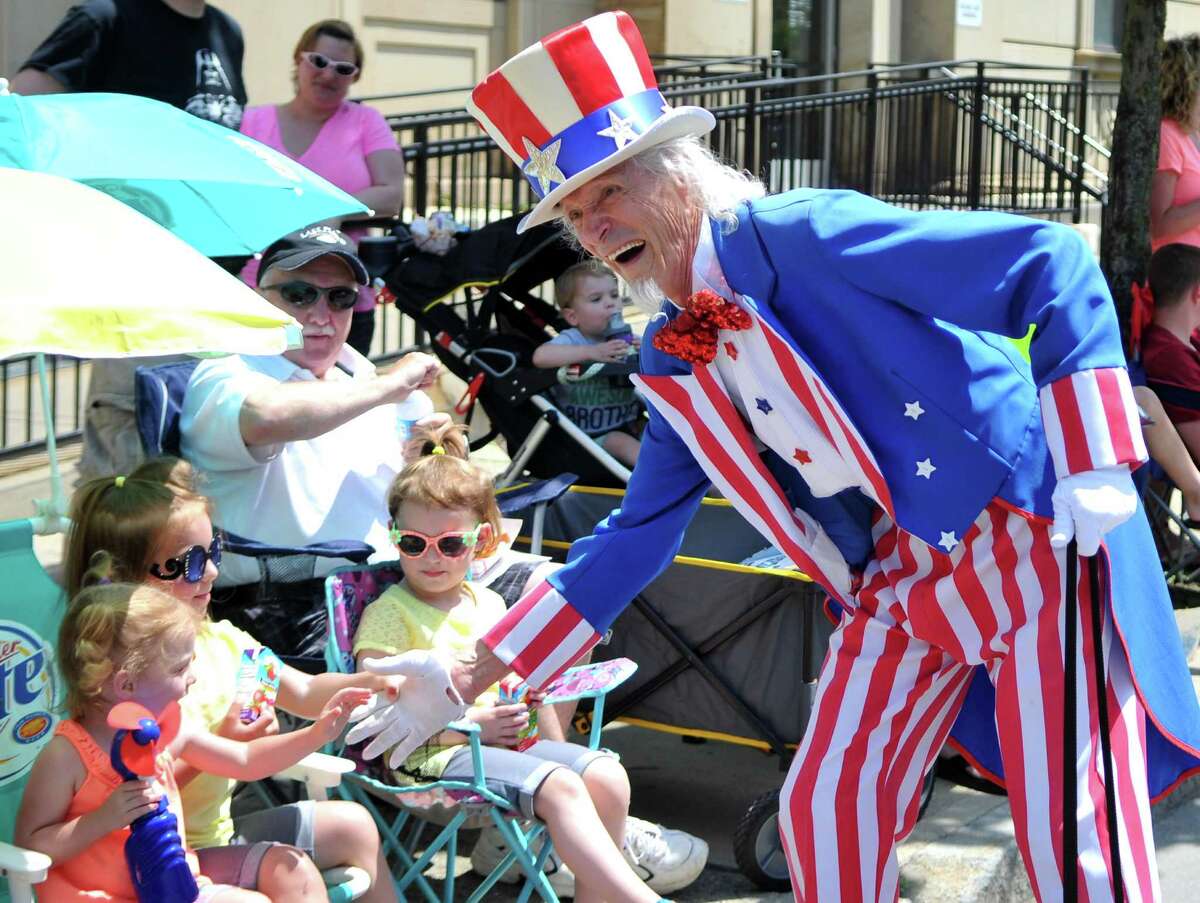 Uncle Sam shakes hands with parade viewers during the 48th Troy Flag Day Parade Sunday, June 14, 2015, in Troy, N.Y. (Phoebe Sheehan/Special to the Times Union)