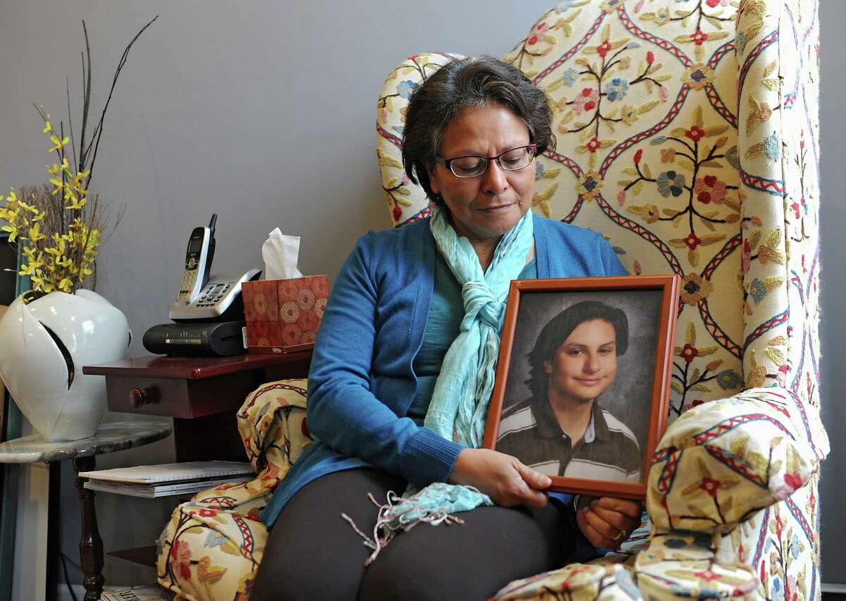 Alicia Barraza holds a framed photograph of her son in her home on Friday, Dec. 12, 2014 in Albany, N.Y. Alicia's son Benjamin Van Zandt hung himself in his prison cell last month at age 21. He had a history of mental illness and was sent to state prison at 17 for arson. (Lori Van Buren / Times Union)