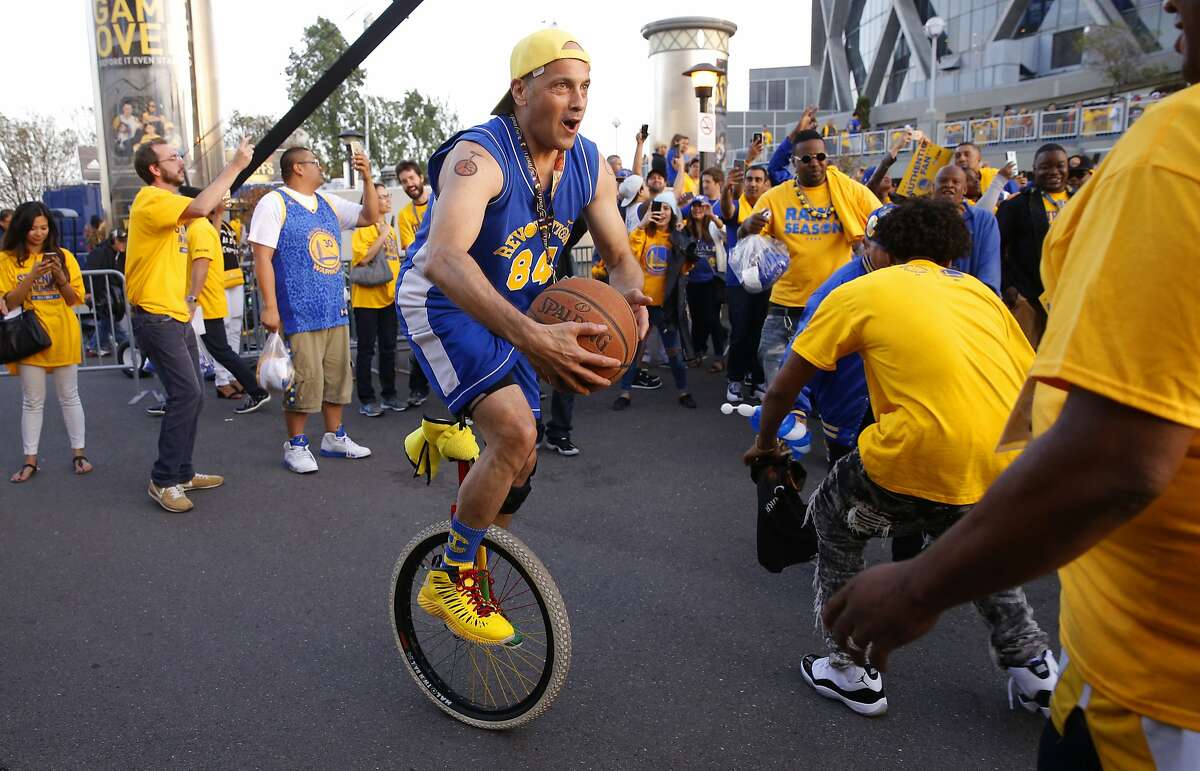 Jim Sowers of Oakland rides his unicycle during the celebration of the victory as the Golden State Warriors beat the Cleveland Cavaliers in game 5, of the NBA finals 104-91 at Oracle Arena in Oakland, , Calif., as seen on Sun. June 14, 2015.
