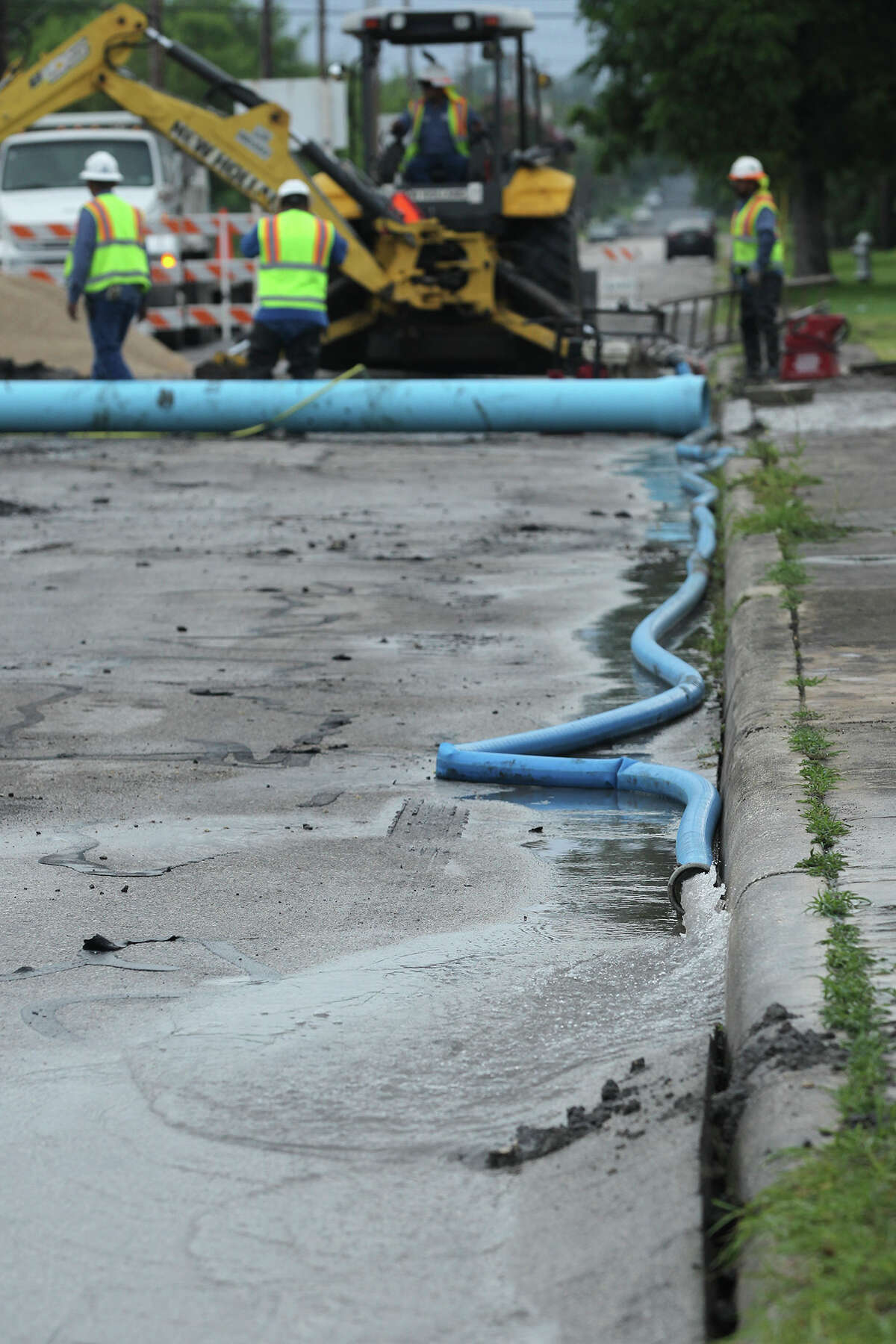 Excavator falls into hole created by water main break on East Side