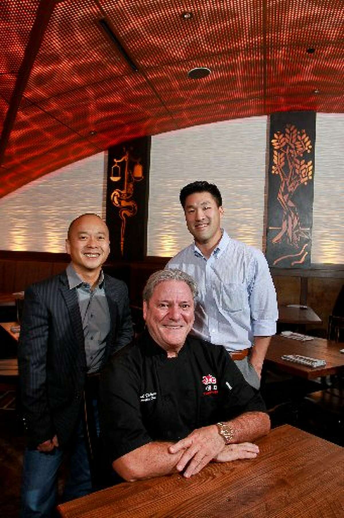 From left, Michael Tran, Paul Friedman and Thomas Nguyen, co-owners of Peli Peli restaurants.