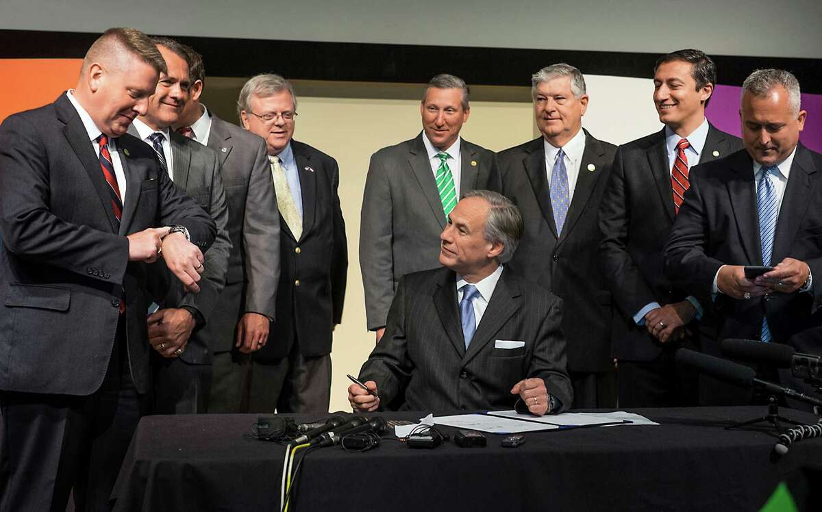 What Texans should remember when they consider giving themselves a tax cut in November is that the Legislature already trimmed the revenues going to the state treasury. Texas Gov. Greg Abbott looks over towards Rep. Tony Dale, R-Cedar Park, far left, before signing House Bill 32, franchise tax cut, during a bill signing ceremony held at Advance Micro Devices in Austin on June 15. , 2015.