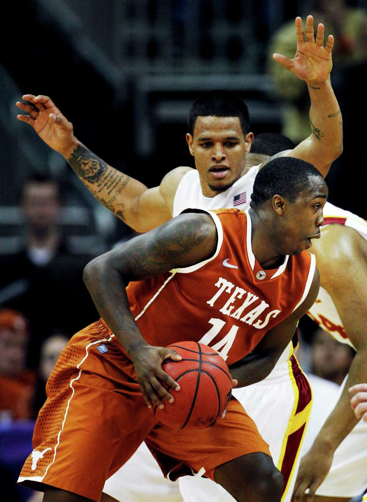 Texas guard J’Covan Brown drives around Iowa State guard Chris Babb during the second half of game in the Big 12 Conference tournament on March 8, 2012, in Kansas City, Mo.