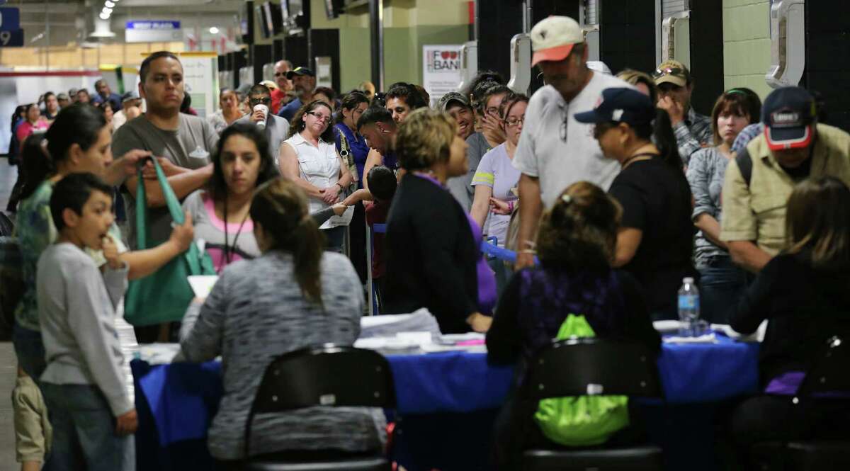 People line up to enroll for health insurance under the Affordable Care Act at the Alamodome in March 2014. Nationally, about 1 million children gained health insurance between 2013 and 2014, according to a study by the Robert Wood Johnson Foundation.
