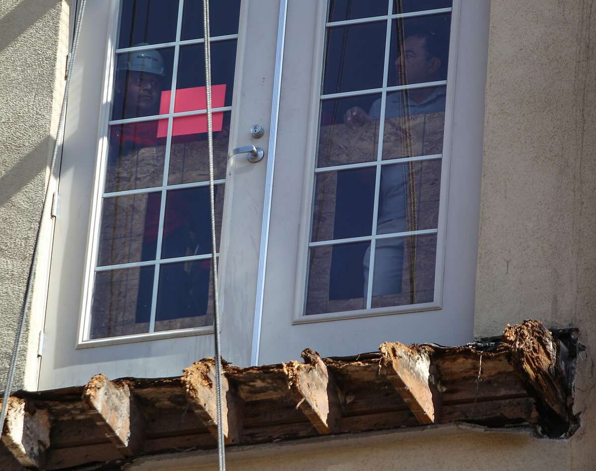 Workers are seen inside the apartment where a balcony collapsed at 2020 Kittredge Street in Berkeley, California, on Tuesday, June 16, 2015. The collapse, which took place in the early hours of Tuesday, killed 6 and injured others.