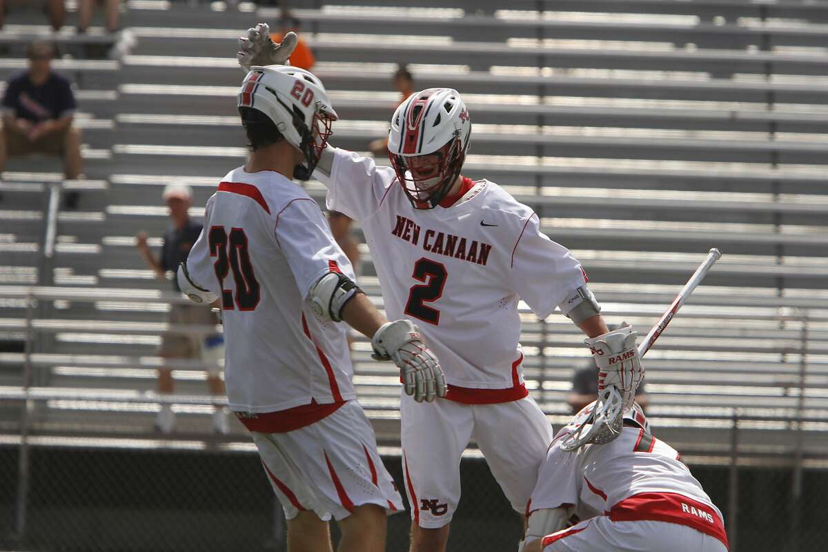 New Canaan's Justin Meichner, right, celebrates with Kyle Smith after scoring a short handed goal against Daniel Hand during the CIAC Class M Boys Lacrosse Championship in Norwalk, Conn. on Saturday, June 13, 2015.