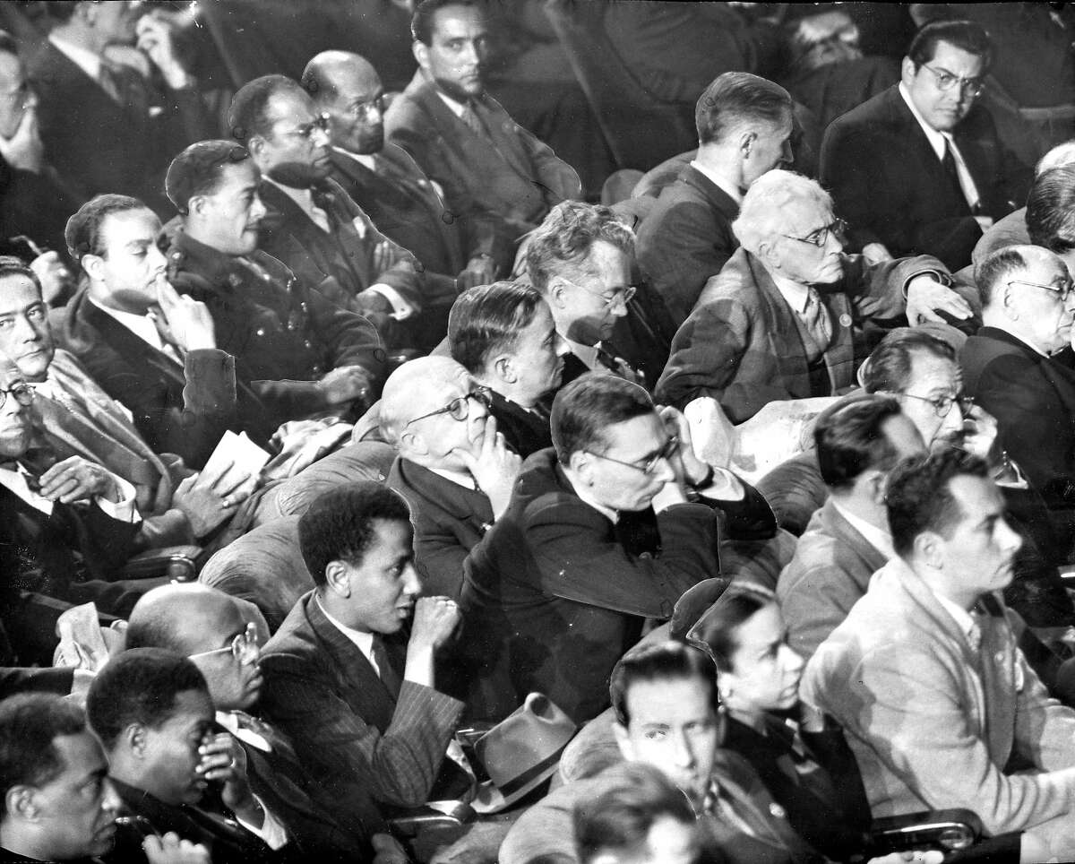 The delegates listen to speakers, In the photo: Haitians occupy the last row, They are (l to r) General Alfred Nemours, Andre Liautaud, Pierre Chauvet, Major Antoine Levelt, Antoine Bervin, Clovis Kernian and Joseph Nadal. In the middle row are Ethiopian representatives sit together at the left., with the rest occupied by French delegates. Leaning forward is Georges Bidault, Minister of Foreign Affairs and chairman of the delegation,and behind him, with his arm on the chair is whit-haired Joseph Paul-Boncour Sittig next to Mr. Paul-Boncour is Henri Bonnet, French ambassador to the U.S. In the front row are the Cuban delegates, Ambassador Guillermo Belt is the first one, facing the camera. Photo ran 04/27/1945, p. 10 Chronicle photo, but a general photographer credit United Nations conference